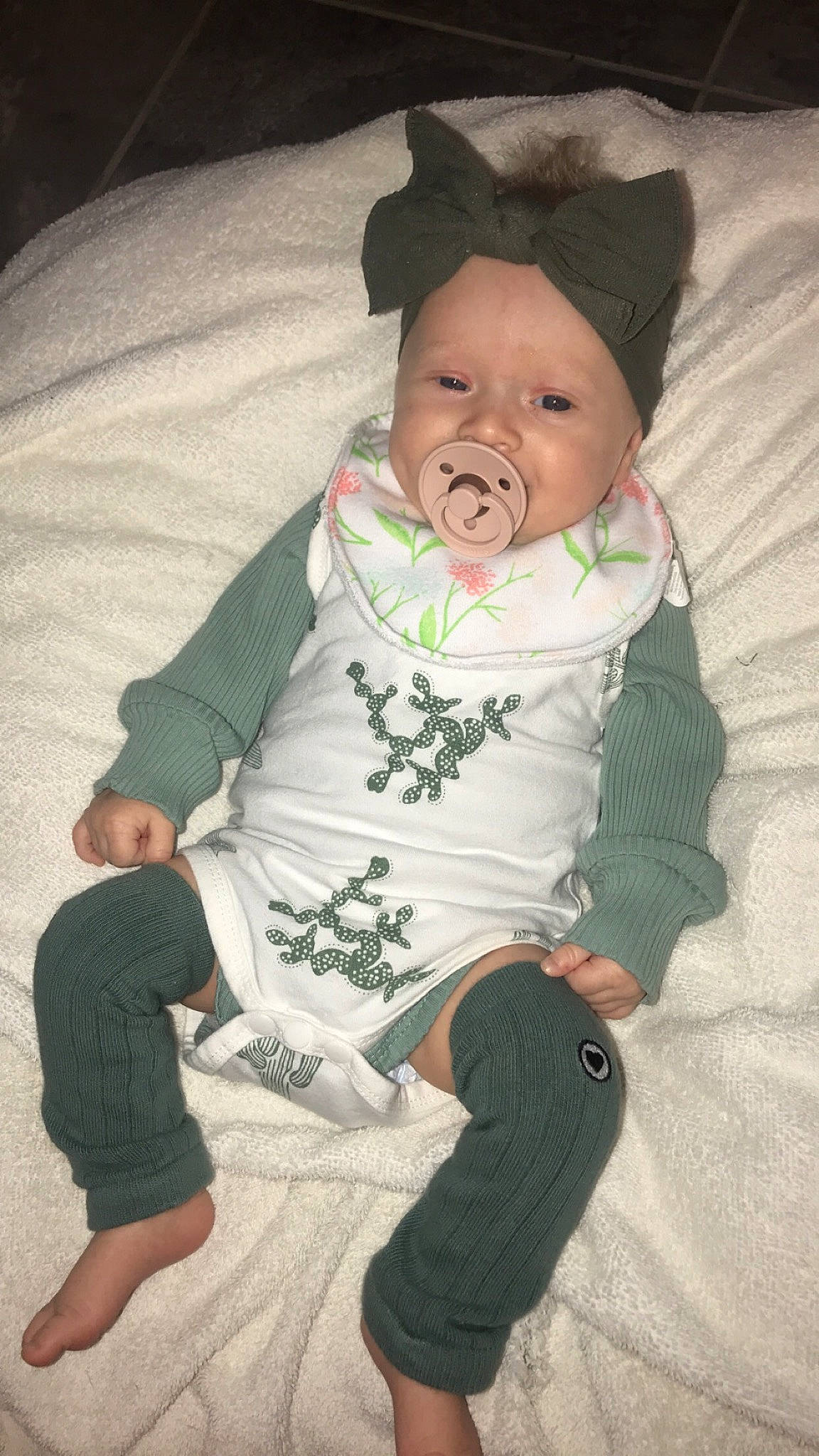 Hadley is registered to the contest to win money with this photo: baby, baby_toddler_clothing, cheek, child, comfort, eye, facial_expression, finger, fun, gesture, headwear, leg, mammal, mouth, nose, person, sitting, skin, sleeve, standing