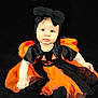 Athénaïs a rejoint le concours — aidez-le/la à gagner de superbes lots ! baby, child, costume, halloween, pumpkin, black, orange, dress, headband, bow, sitting, portrait, cute, blue_eyes, infant, holiday, festive, studio, photography, dark_background