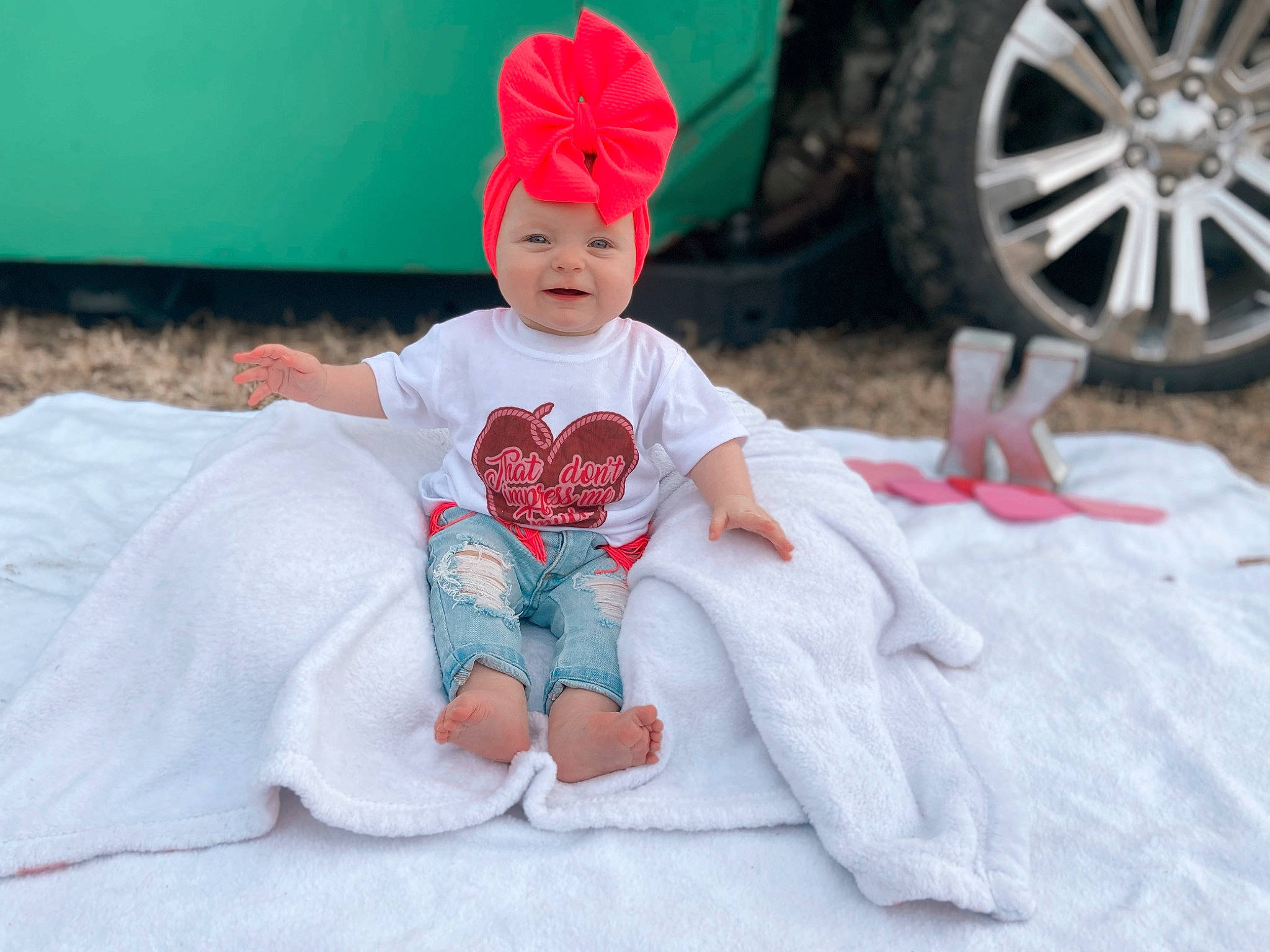 Kinzley joined the competition — help win amazing prizes! automotive_tire, automotive_wheel_system, baby, baby_toddler_clothing, cap, child, comfort, event, fashion_accessory, fun, grass, happy, hat, headwear, leisure, person, pink, sitting, t_shirt, tire