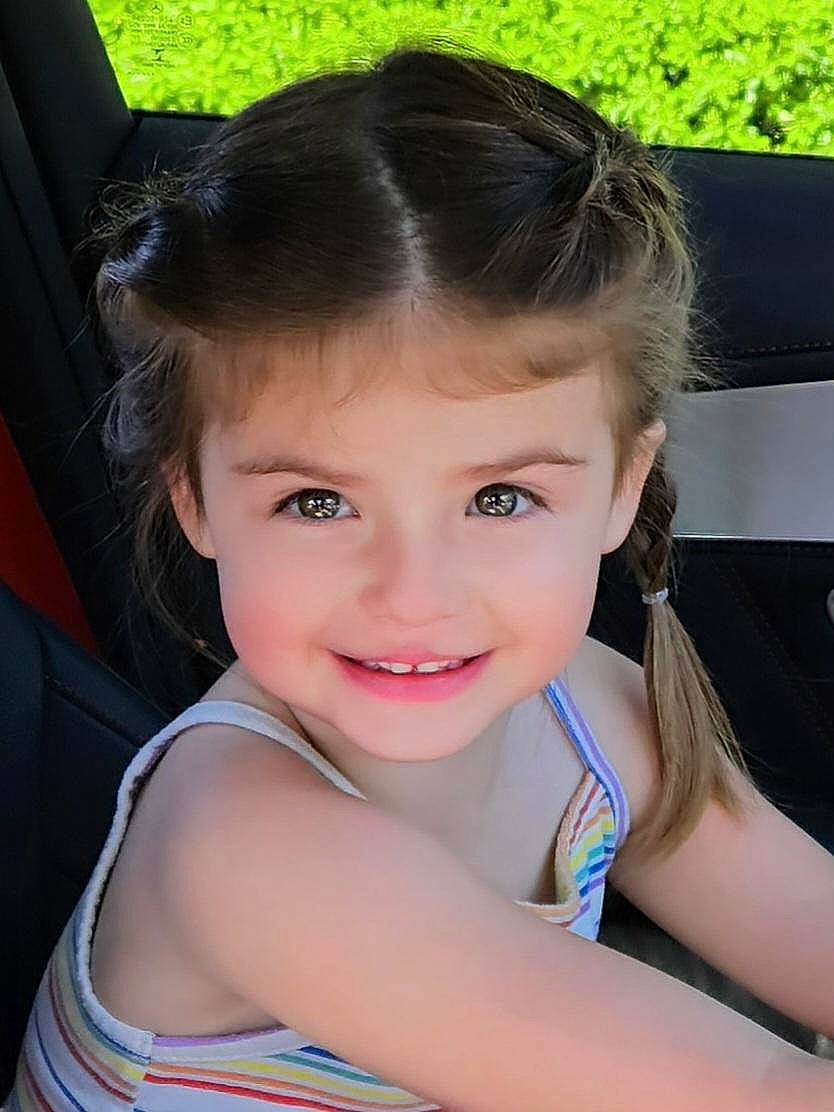 Gwen is registered to the contest to win money with this photo: brown_hair, cheek, child, chin, electric_blue, eyebrow, eyelash, fashion_accessory, flash_photography, fun, hair_accessory, hair_tie, happy, iris, joy, leisure, lip, person, sitting, skin