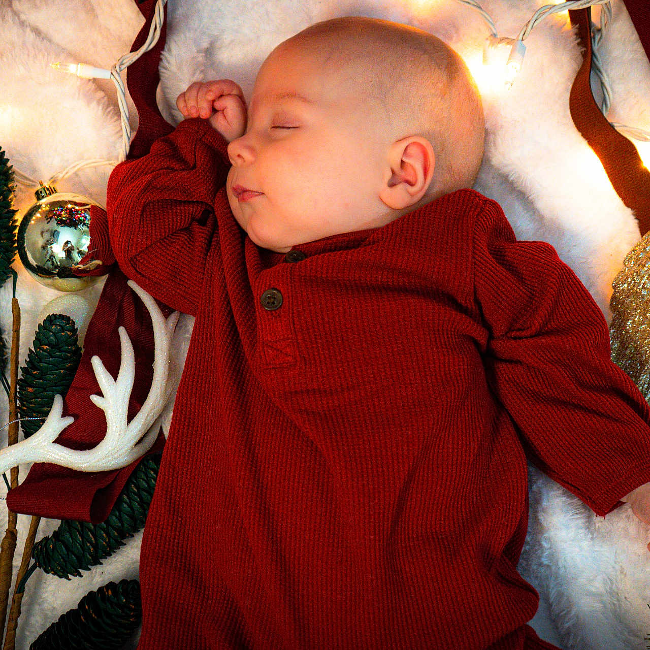 Jack is registered to the contest to win money with this photo: angel_wings, baby, blanket, christmas_lights, cozy, cute, decoration, festive, holiday, holiday_theme, indoor, infant, ornaments, peaceful, pinecones, portrait, red_clothing, sleeping, soft_texture, warm_colors