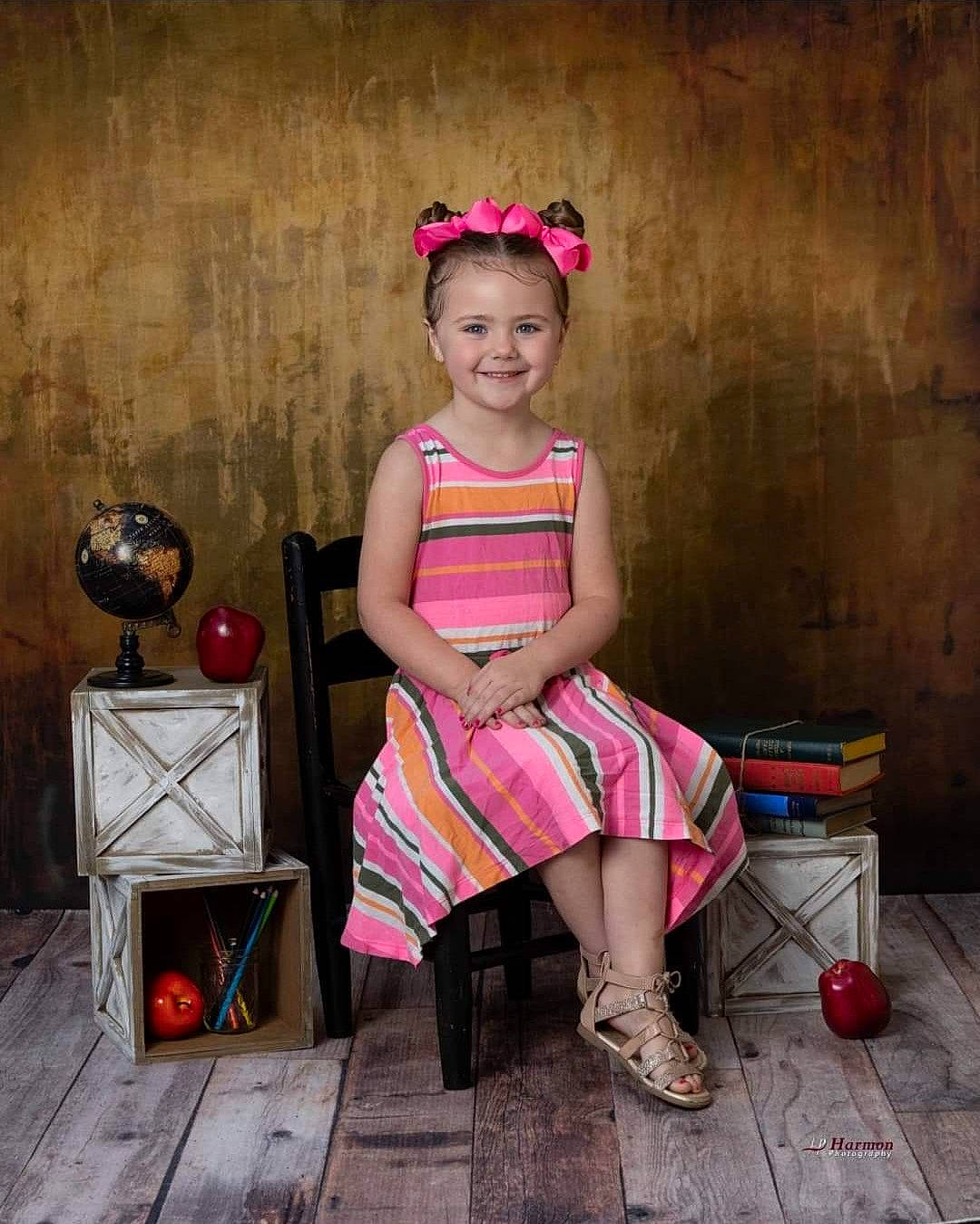 Harleigh joined the competition — help win amazing prizes! art, child, dress, fashion_accessory, fashion_design, flash_photography, fun, happy, headpiece, human_leg, joy, magenta, pattern, person, pink, room, sandal, sitting, smile, stool