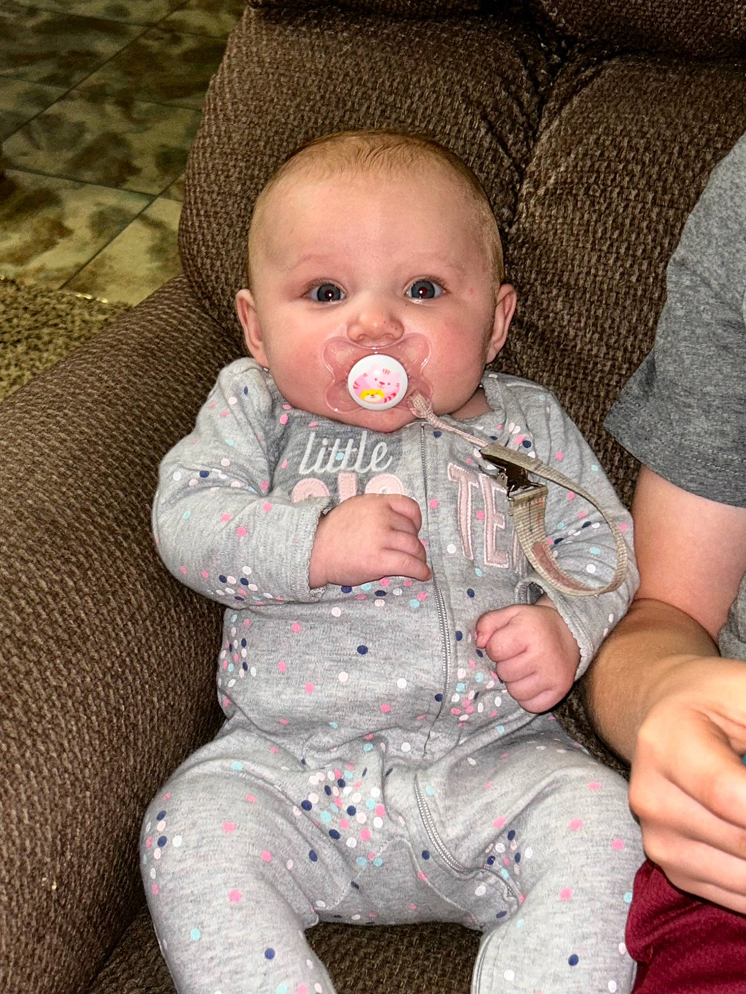 Roseilia is registered to the contest to win money with this photo: baby, baby_products, baby_toddler_clothing, cheek, child, comfort, eye, face, grass, head, iris, lip, mouth, nose, pattern, person, pink, sitting, skin, sleeve