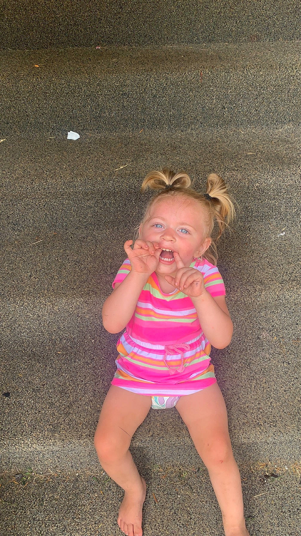 Raelynn is registered to the contest to win money with this photo: baby, baby_toddler_clothing, dress, eye, finger, flash_photography, foot, fun, grass, happy, human_leg, knee, magenta, pattern, person, pink, sitting, skin, smile, thigh