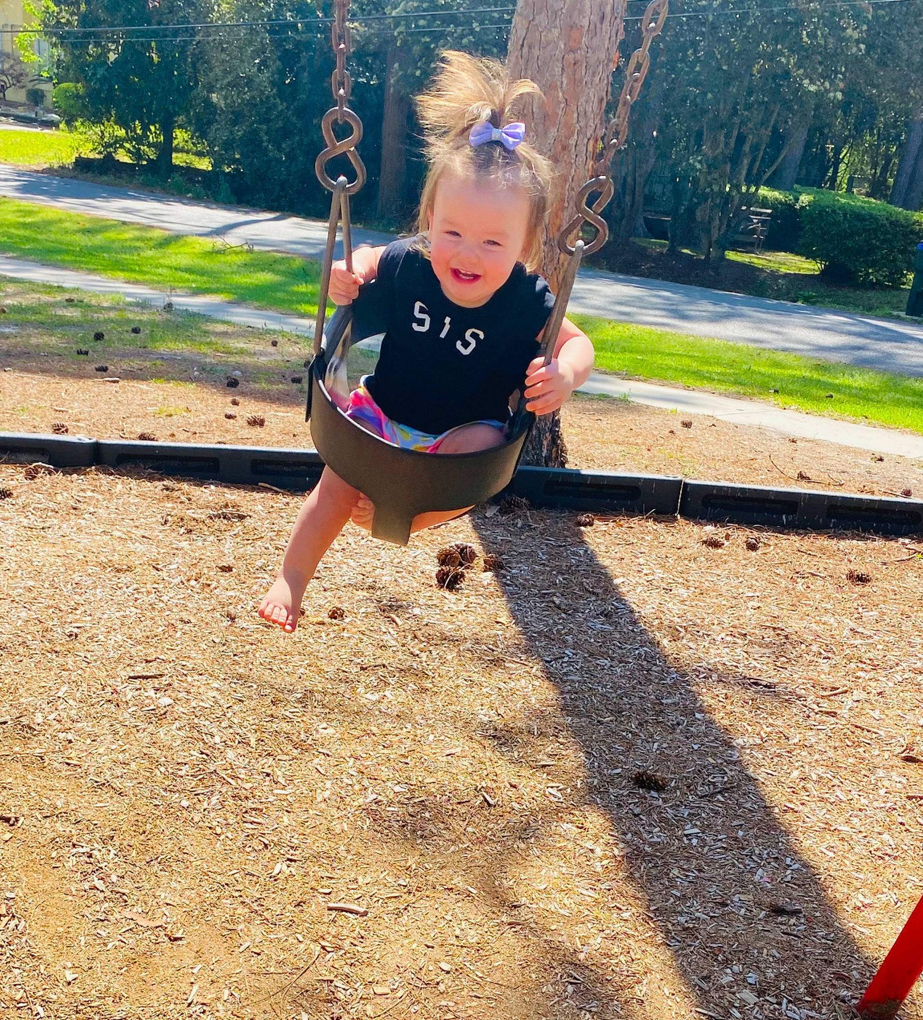 Annika is registered to the contest to win money with this photo: city, electric_blue, fun, grass, happy, joy, knee, leisure, outdoor_play_equipment, people_in_nature, person, plant, playground, recreation, swing, t_shirt, thigh, tints_and_shades, toddler, tree