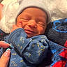 Akari is registered to the contest to win money with this photo: newborn, baby, infant, portrait, sleeping, smiling, hat, beanie, blue_clothing, onesie, blanket, swaddled, face, eyes_closed, indoors, cozy, hand, manicure, close_up, family