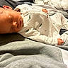 newborn, baby, sleeping, infant, child, portrait, indoors, blanket, clothing, onesie, dinosaur_print, bed, soft, cozy, peaceful, resting, face, closed_eyes, photography, cute