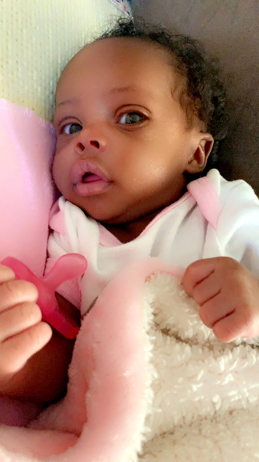 Jaliyah is registered to the contest to win money with this photo: baby, baby_toddler_clothing, cheek, comfort, eyelash, finger, gesture, hand, happy, iris, linens, lip, mouth, nose, person, pink, skin, sleeve, textile, thumb