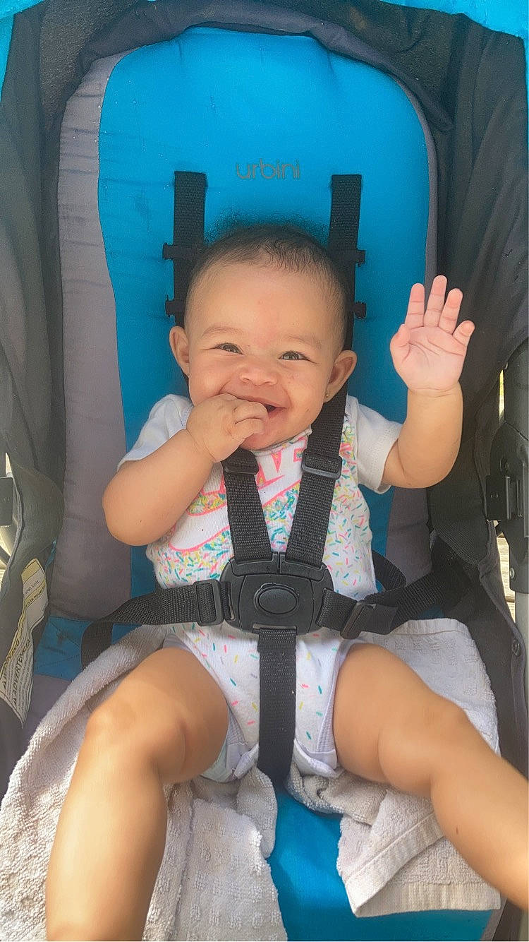 Arielle is registered to the contest to win money with this photo: azure, baby, baby_toddler_clothing, blue, car_seat, chair, cheek, comfort, finger, happy, human_body, joy, lap, leg, people, person, product, skin, smile, thigh
