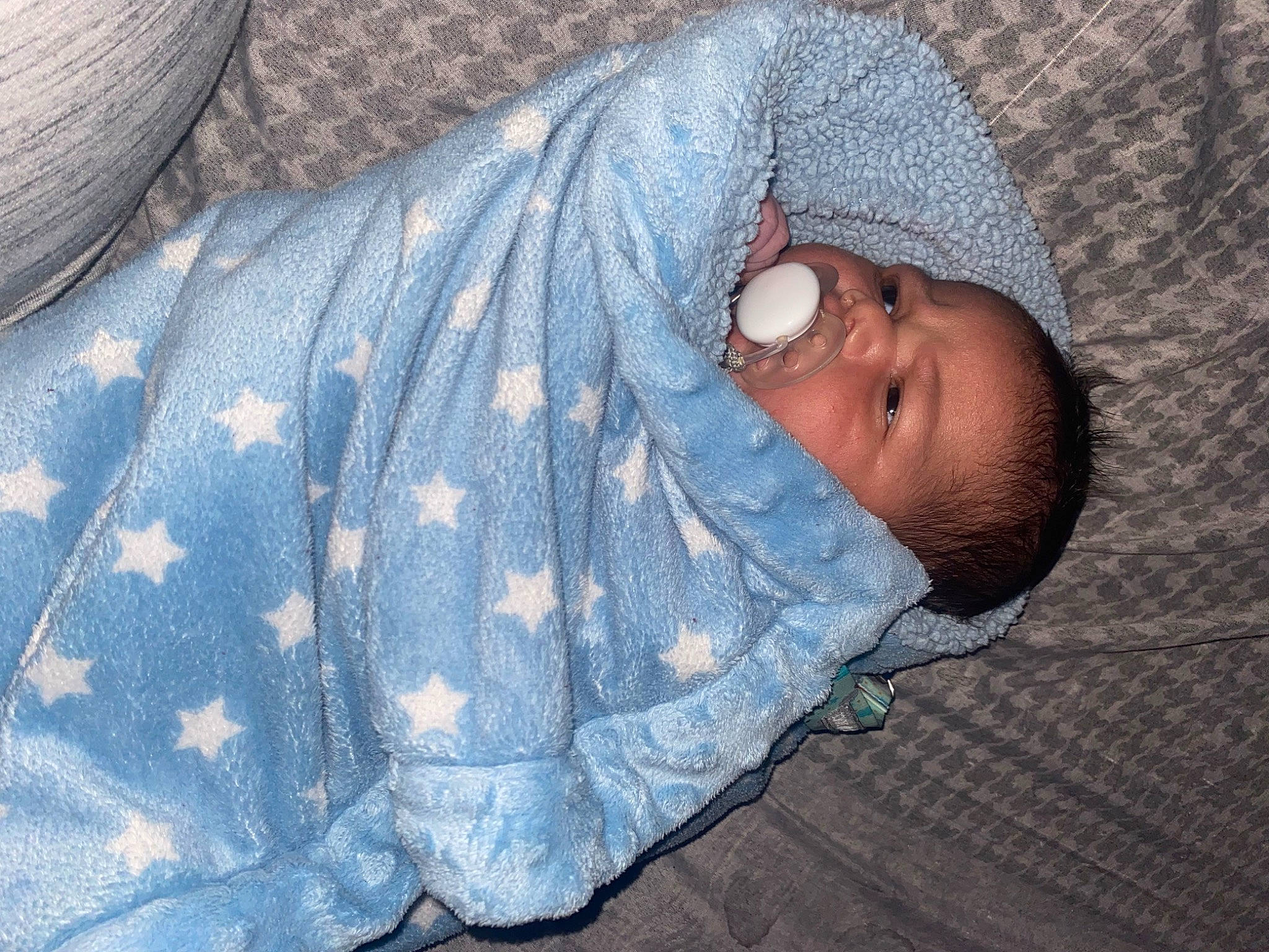 Kamari joined the competition — help win amazing prizes! baby, baby_products, baby_toddler_clothing, bedding, bedtime, child, comfort, electric_blue, grey, hand, human_body, linens, nap, nose, pattern, person, skin, sleeve, textile, toddler