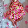 baby, pacifier, pink_dress, flower, blanket, infant, cute, lying_down, soft_texture, pink_flower, infant_clothing, adorable, portrait, child, floral_pattern, relaxed, skin, small_feet, indoors, peaceful
