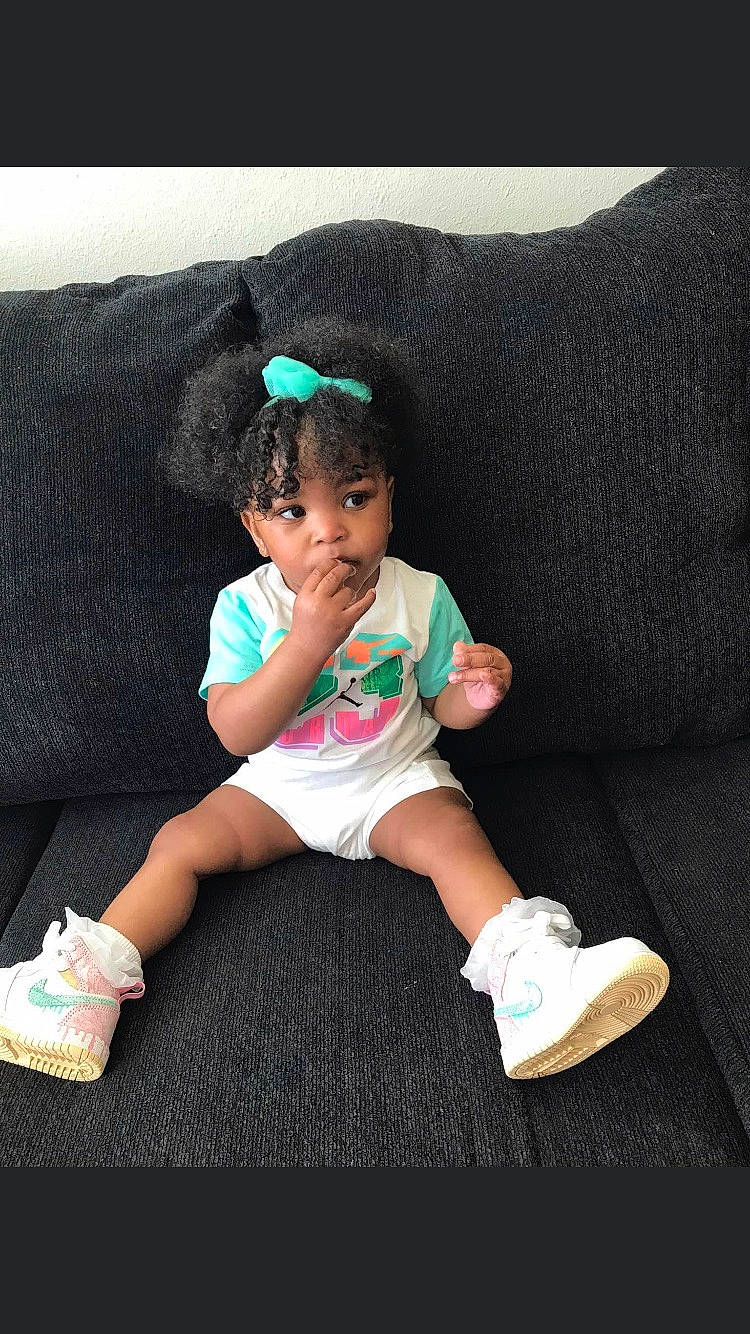 Zoey is registered to the contest to win money with this photo: baby, baby_toddler_clothing, comfort, couch, flash_photography, grass, happy, hat, head, human_leg, knee, leg, person, shoe, shorts, sleeve, sneakers, sock, t_shirt, thigh