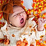Evelyn is registered to the contest to win money with this photo: baby, yawning, headband, bow, pumpkin_print, orange, candy_corn, fall, autumn, cute, infant, sleepy, clothing, pattern, small_hand, soft_texture, portrait, festive, cozy, lying_down