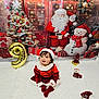 toddler, child, santa_hat, christmas_outfit, holiday_decor, balloon, number_9, christmas_tree, snowman, santa_claus, gift_boxes, festive, smiling, indoor, carpet, red_clothing, white_fur_trim, celebration, cute, christmas_theme