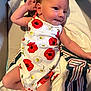 Cierra joined the competition — help win amazing prizes! baby, infant, onesie, flower_pattern, blanket, striped_blanket, soft_fabric, lying_down, curious_expression, raised_hand, cute, skin, head, arm, leg, indoors, closeup, child, portrait, resting