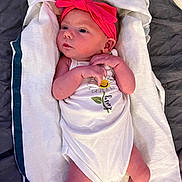 Cierra joined the competition — help win amazing prizes! baby, infant, towel, onesie, headband, pink, white_clothing, flower_print, laying_down, blanket, newborn, skin, cute, child, person, indoors, resting, portrait, small_hands, sleepwear