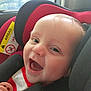baby, smiling, car_seat, child, infant, happy, face, safety, car, seatbelt, pacifier, red, black, window, closeup, cute, young, indoors, child_safety, cheerful