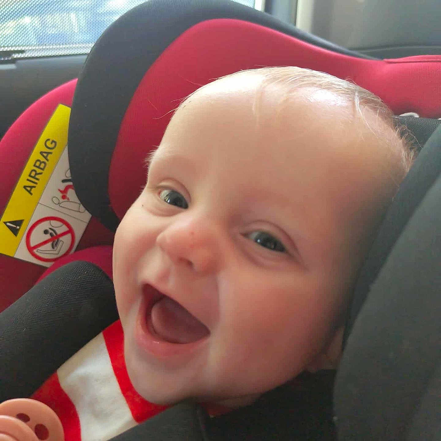 Dantè joined the competition — help win amazing prizes! baby, black, car, car_seat, cheerful, child, child_safety, closeup, cute, face, happy, indoors, infant, pacifier, red, safety, seatbelt, smiling, window, young
