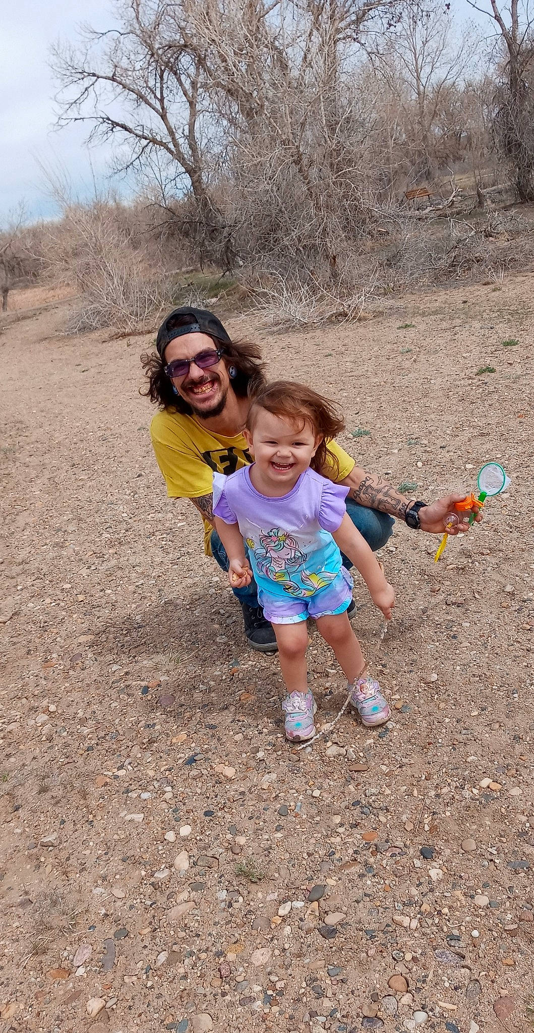 Xayah is registered to the contest to win money with this photo: child, face, fun, grass, happy, headwear, joy, landscape, leisure, mammal, people_in_nature, person, plant, recreation, sand, shorts, sky, smile, soil, t_shirt