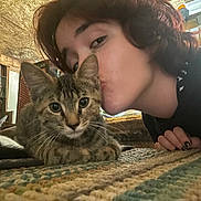 Nala is registered to the contest to win money with this photo: abyssinian, adult, animal, bodypart, cat, couch, face, female, finger, furniture, hand, head, indoors, kitten, manx, person, pet, photography, portrait, woman