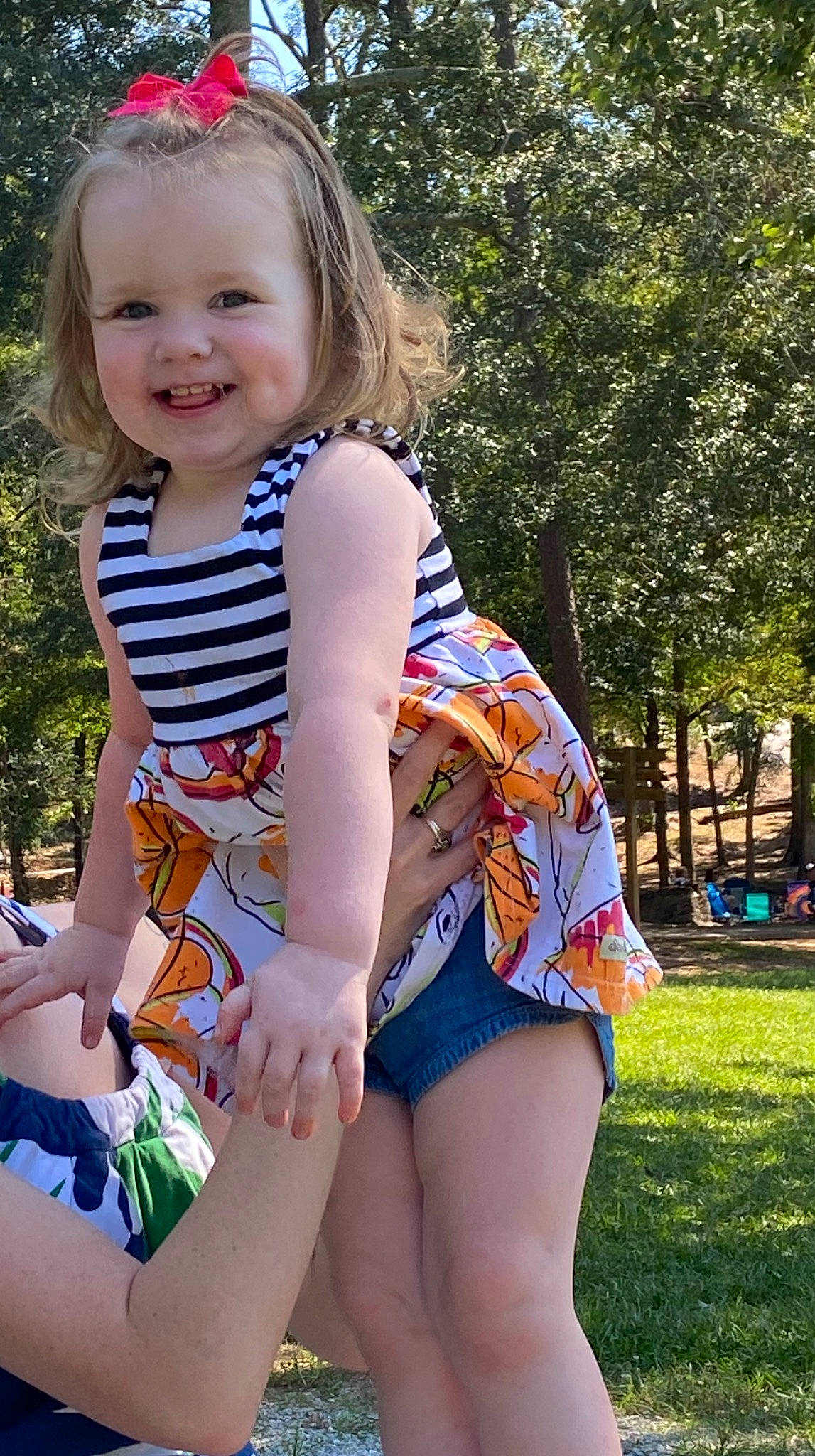 Olivia is registered to the contest to win money with this photo: child, grass, joy, leg, person, play, shorts, sitting, smile, summer, thigh, toddler, vacation