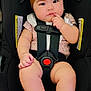 accessories, baby, belt, bonnet, cap, car, car_interior, carseat, clothing, costume, dress, face, hat, head, person, photography, portrait, sitting, transportation, vehicle