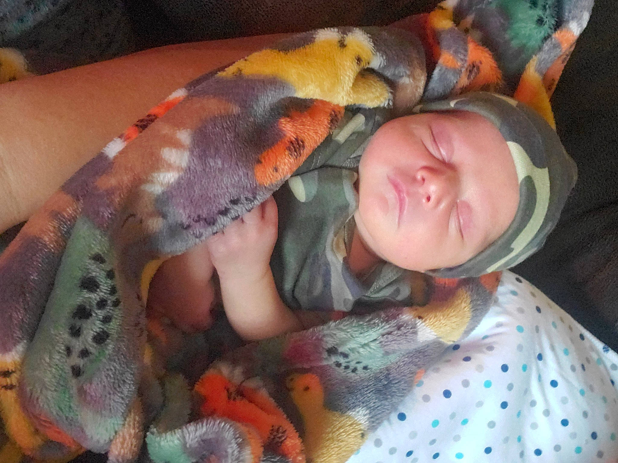 Ryder is registered to the contest to win money with this photo: baby, baby_products, baby_toddler_clothing, bedding, bedtime, blanket, child, comfort, eye, headwear, lap, linens, nail, nap, orange, pattern, person, room, serpent, sleep