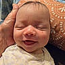 Mackenzie is registered to the contest to win money with this photo: baby, newborn, infant, smiling, sleeping, eyes_closed, portrait, face, closeup, child, indoors, cushion, blanket, clothing, polkadots, hand, cradled, happy, cozy, photography