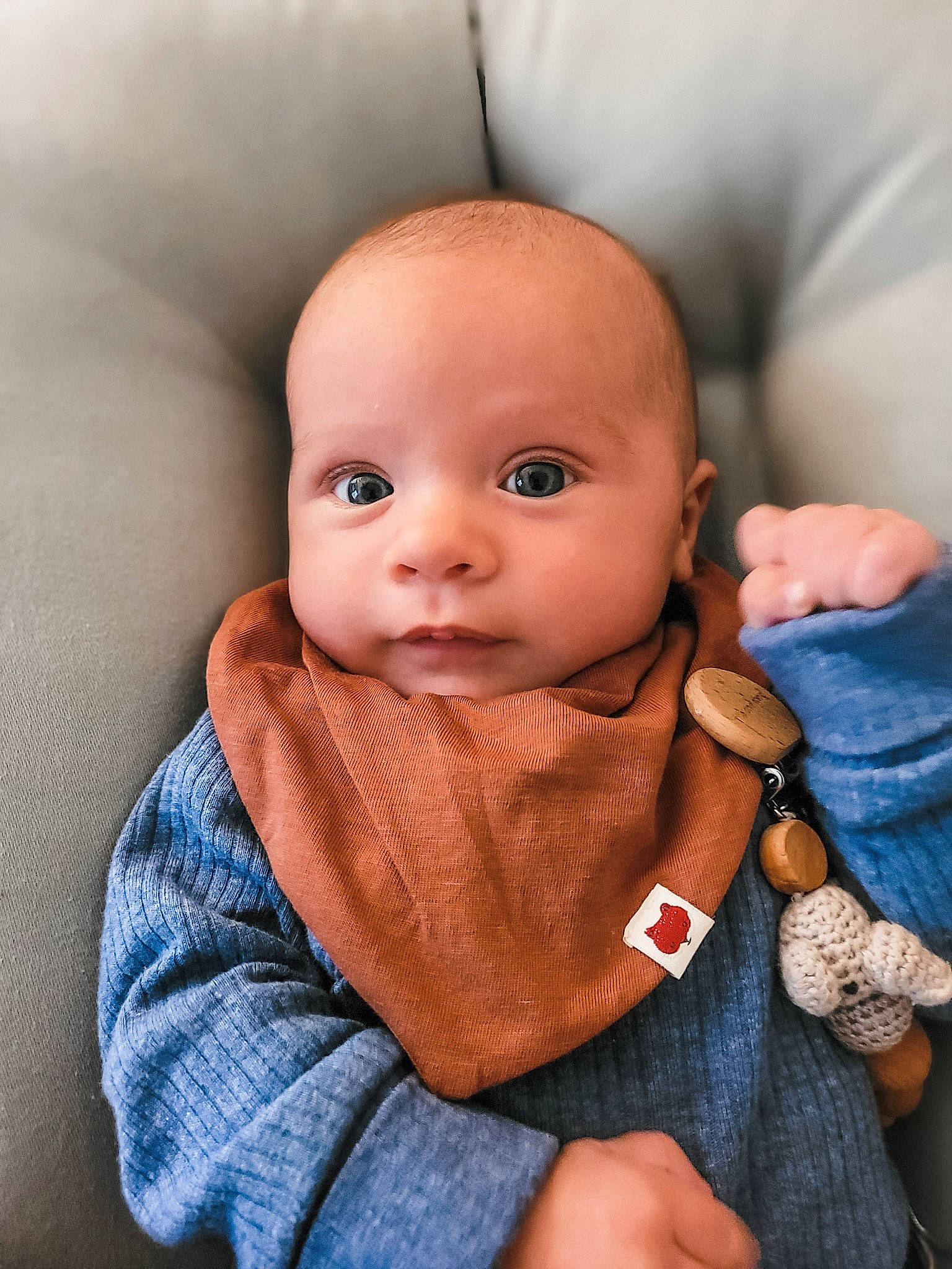 Eli is registered to the contest to win money with this photo: baby, baby_toddler_clothing, cheek, child, collar, comfort, eye, face, gesture, head, iris, linens, lip, nail, nose, person, skin, sleeve, thumb, toddler