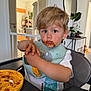 bib, blonde_hair, child, door, expression, face, food, hands, high_chair, home, indoor, meal_time, messy, mirror, plant, plate, spaghetti, table, toddler, white_shirt