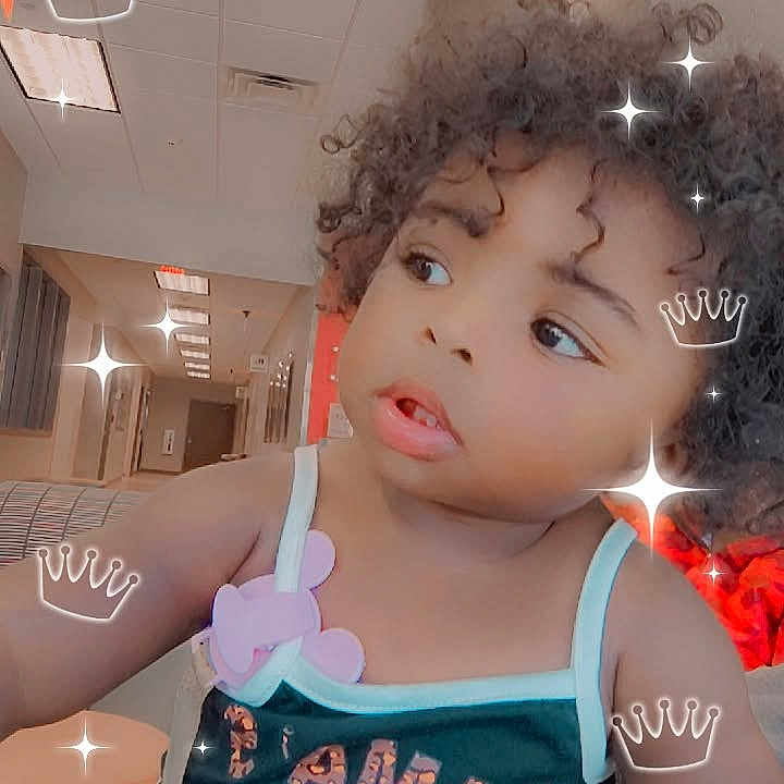 Carlalani is registered to the contest to win money with this photo: toddler, child, curly_hair, indoor, sparkles, crowns, baby, cute, portrait, person, clothing, tank_top, expression, playful, decorative_effects, young_child, face, head, skin, photography