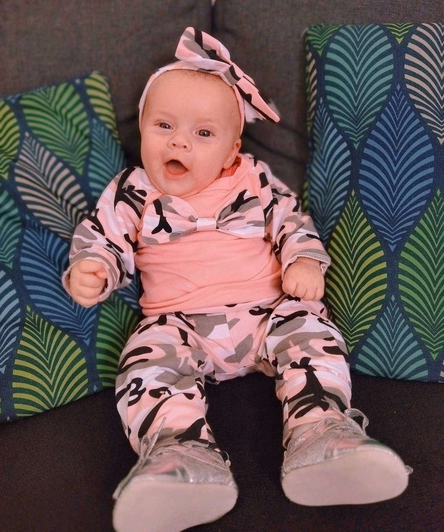 Joy participe au concours pour gagner de l'argent avec cette photo : baby, baby_products, baby_toddler_clothing, cheek, child, comfort, eye, grass, happy, human_body, linens, pattern, person, pink, sitting, skin, sleeve, smile, textile, thigh