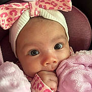 Miyanni is registered to the contest to win money with this photo: baby, infant, face, headband, bow, pink, blanket, hand, eyes, cute, soft, clothing, portrait, closeup, child, cozy, warm, expression, indoors, toddler