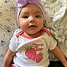 Miyanni is registered to the contest to win money with this photo: baby, infant, headwrap, bow, onesie, strawberry, text, floral_pattern, blanket, cute, smiling, portrait, child, indoors, soft_lighting, skin, face, eyes, pink, white