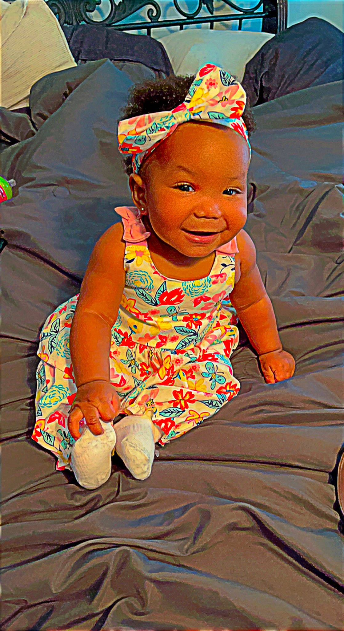 Dalani is registered to the contest to win money with this photo: adaptation, baby, baby_toddler_clothing, child, comfort, facial_expression, fun, happy, headgear, leisure, mouth, people, people_in_nature, person, pink, sitting, skin, sleeve, smile, textile