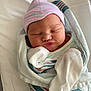 Everleigh is registered to the contest to win money with this photo: architecture, baby, bed, blanket, building, clothing, crib, face, furniture, glove, hat, head, hospital, newborn, person, photography, portrait, quilt, sleeping, towel