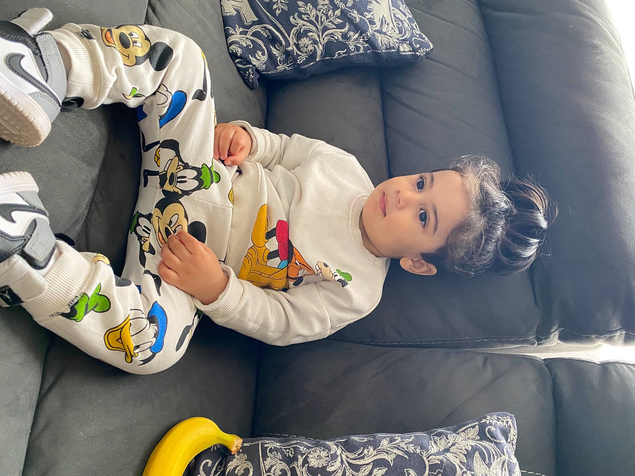 Ayaan is registered to the contest to win money with this photo: arm, baby, baby_sleeping, baby_toddler_clothing, comfort, couch, facial_expression, finger, hairstyle, hand, head, headgear, human_body, leg, person, sleeve, t_shirt, textile, thigh, toddler