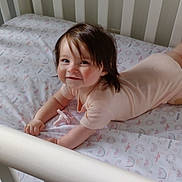 Elsy is registered to the contest to win money with this photo: baby, crib, pacifier, smiling, toddler, indoor, child, happy, face, hair, sleepwear, patterned_sheet, white_crib, candid, lying_down, cute, infant, pastel_colors, cheerful, tummy_time