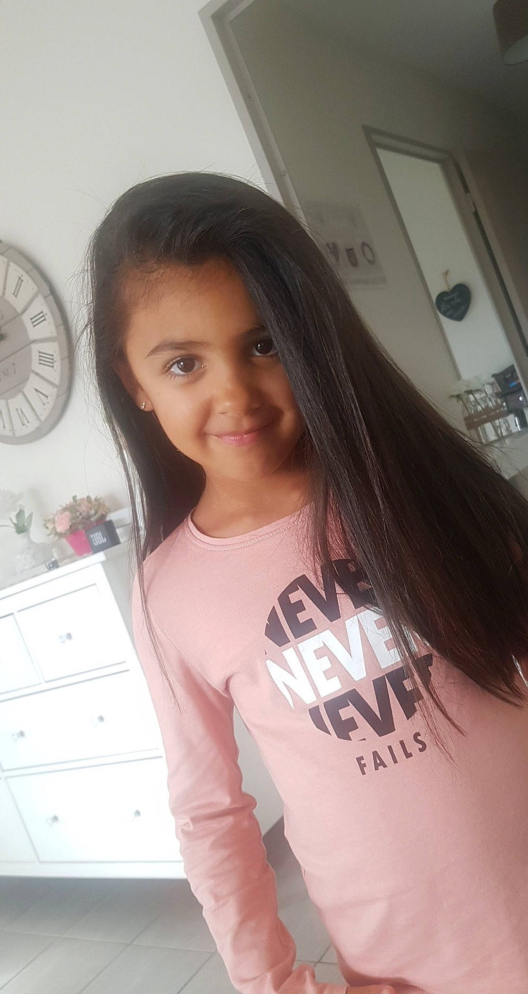 Stella participe au concours pour gagner de l'argent avec cette photo : black_hair, cabinetry, chin, clock, drawer, eye, eyebrow, eyelash, face, facial_expression, forehead, hair, hairstyle, happy, joy, person, skin, sleeve, smile, thigh