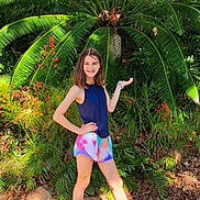 Lena joined the competition — help win amazing prizes! casual, child, daylight, feet, flora, girl, greenery, ground, happy, leaves, nature, outdoor, plant, posing, shoes, shorts, smile, sunlight, tank_top, young