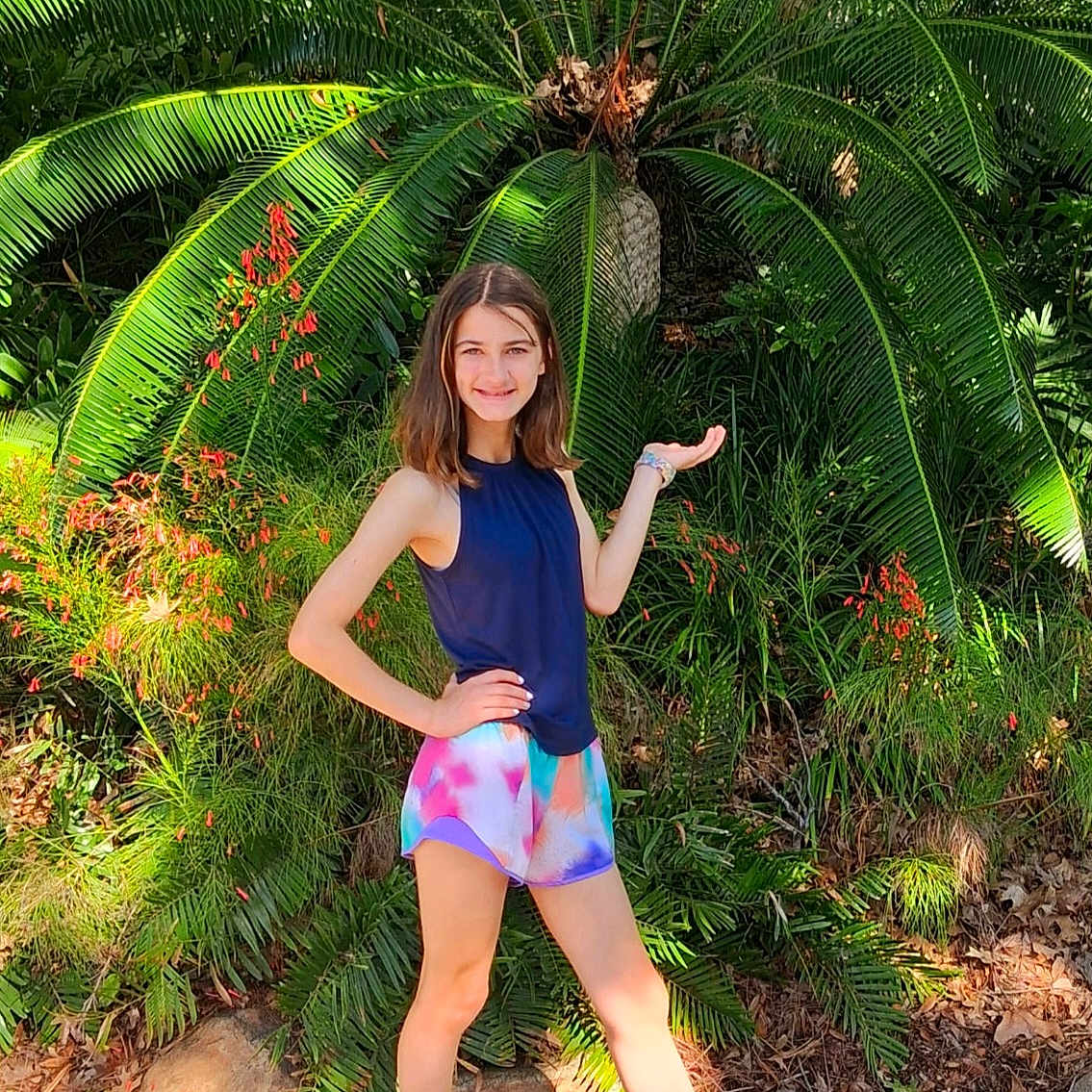 Lena joined the competition — help win amazing prizes! casual, child, daylight, feet, flora, girl, greenery, ground, happy, leaves, nature, outdoor, plant, posing, shoes, shorts, smile, sunlight, tank_top, young