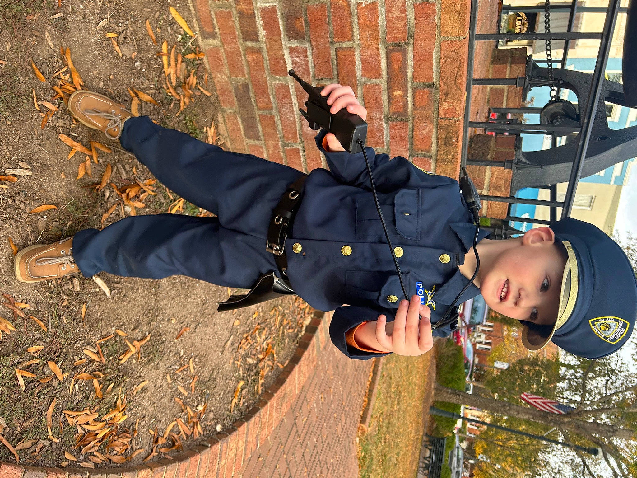 Carter is registered to the contest to win money with this photo: adventure, boot, child, city, flash_photography, fun, grass, happy, headwear, leisure, people_in_nature, person, recreation, road_surface, shadow, shoe, sitting, sneakers, soil, toddler
