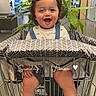 Jaziel joined the competition — help win amazing prizes! toddler, child, shopping_cart, plant, smiling, indoor, store, greenery, happy, feet, sandals, clothing, modern, retail, person, cute, portrait, baby, fun, sitting