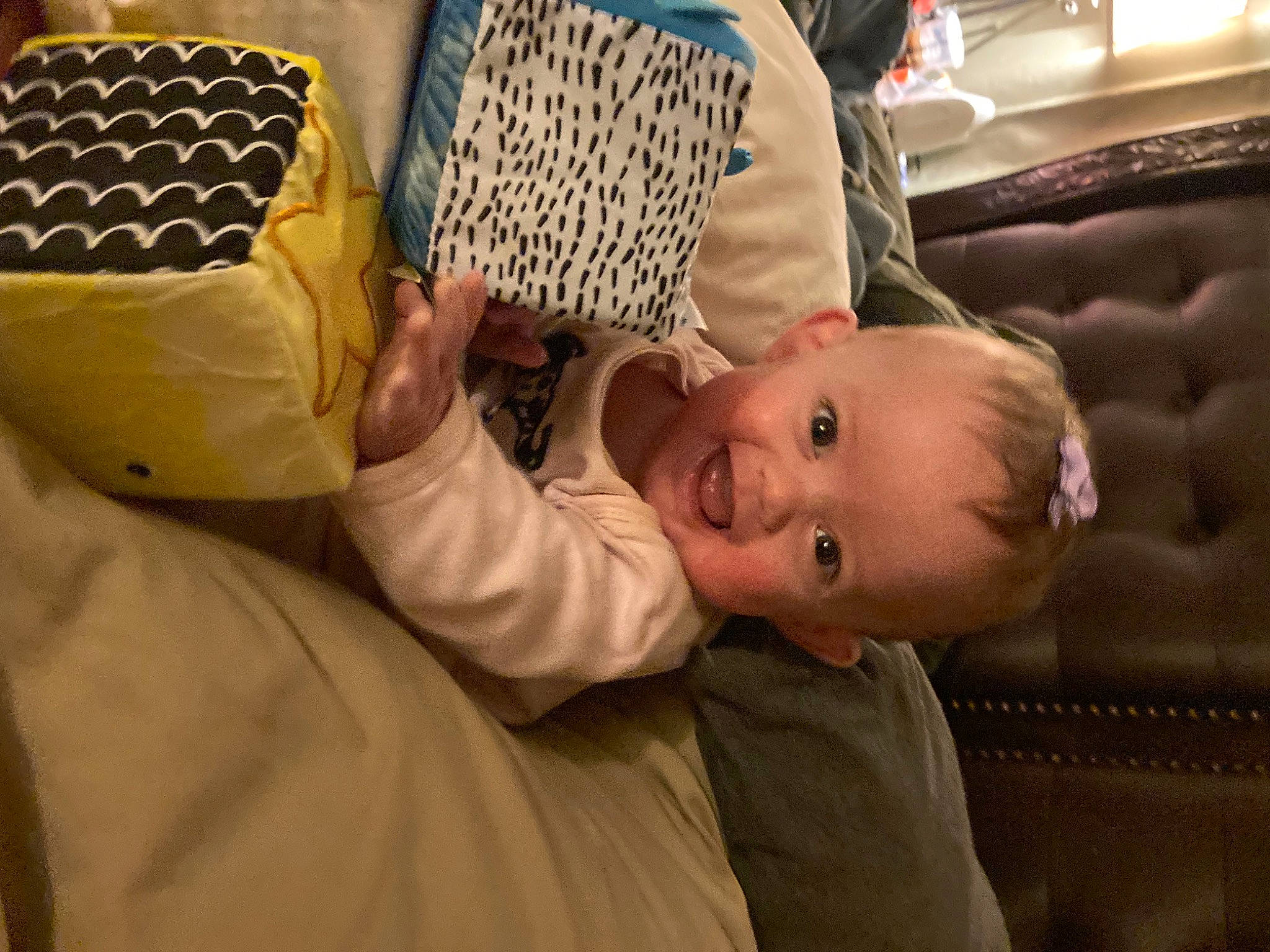 Susie joined the competition — help win amazing prizes! baby, baby_products, baby_toddler_clothing, backpack, chair, child, comfort, couch, flooring, fun, furniture, hand, infant_bed, linens, person, room, sitting, smile, suit, toddler