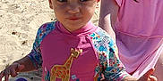 Maisie joined the competition — help win amazing prizes! beach, child, cloudy, footwear, giraffe, hat, outdoor, people, pink_clothing, play, sand, sandcastle, sea, sky, summer, sunny, swimsuit, tent, toddler, water