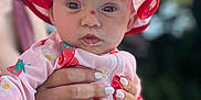 Sophia Grace is registered to the contest to win money with this photo: baby, child, infant, hat, red_bow, strawberry_pattern, pink_outfit, hand, adult_hand, nail_polish, outdoor, sunlight, portrait, cute, closeup, skin, face, eyes, expression, summer