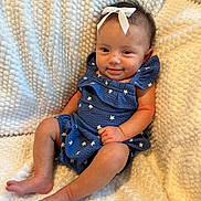 Sophia Grace joined the competition — help win amazing prizes! baby, child, smile, blue_outfit, bow, blanket, cute, infant, sitting, star_pattern, soft_texture, happy, portrait, skin, foot, hand, face, indoors, cozy, young