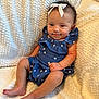 baby, child, smile, blue_outfit, bow, blanket, cute, infant, sitting, star_pattern, soft_texture, happy, portrait, skin, foot, hand, face, indoors, cozy, young