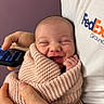 newborn, baby, infant, smiling, wrapped, blanket, knitted, hand, person, fedex, shirt, phone, holding, portrait, happy, cute, face, indoor, closeup, warm