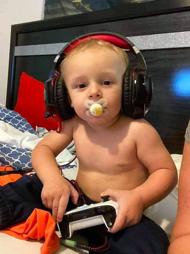 Braxton joined the competition — help win amazing prizes! audio_accessory, audio_equipment, baby, baby_products, baby_toddler_clothing, camera, child, communication_device, electronic_device, gadget, hair_accessory, hand, headphones, hearing, nail, peripheral, person, product, technology, toddler